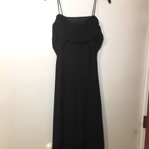 Black cocktail dress with spaghetti straps.